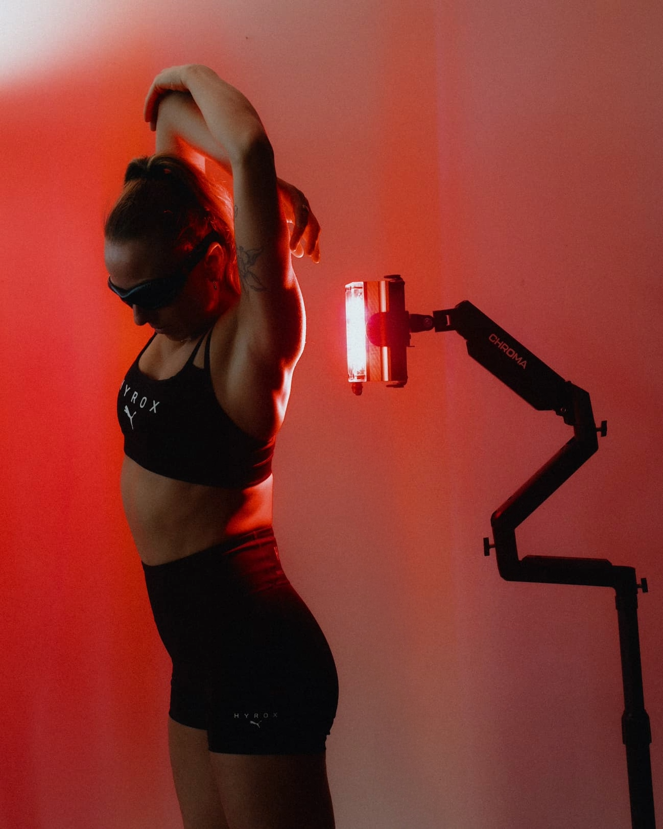 A member relaxing inside a red light therapy bed during an in-studio session
